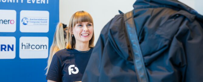 Empfang bei der FORMCYCLE Connect in Würzburg mit Teilnehmer und lächelnder Mitarbeiterin.